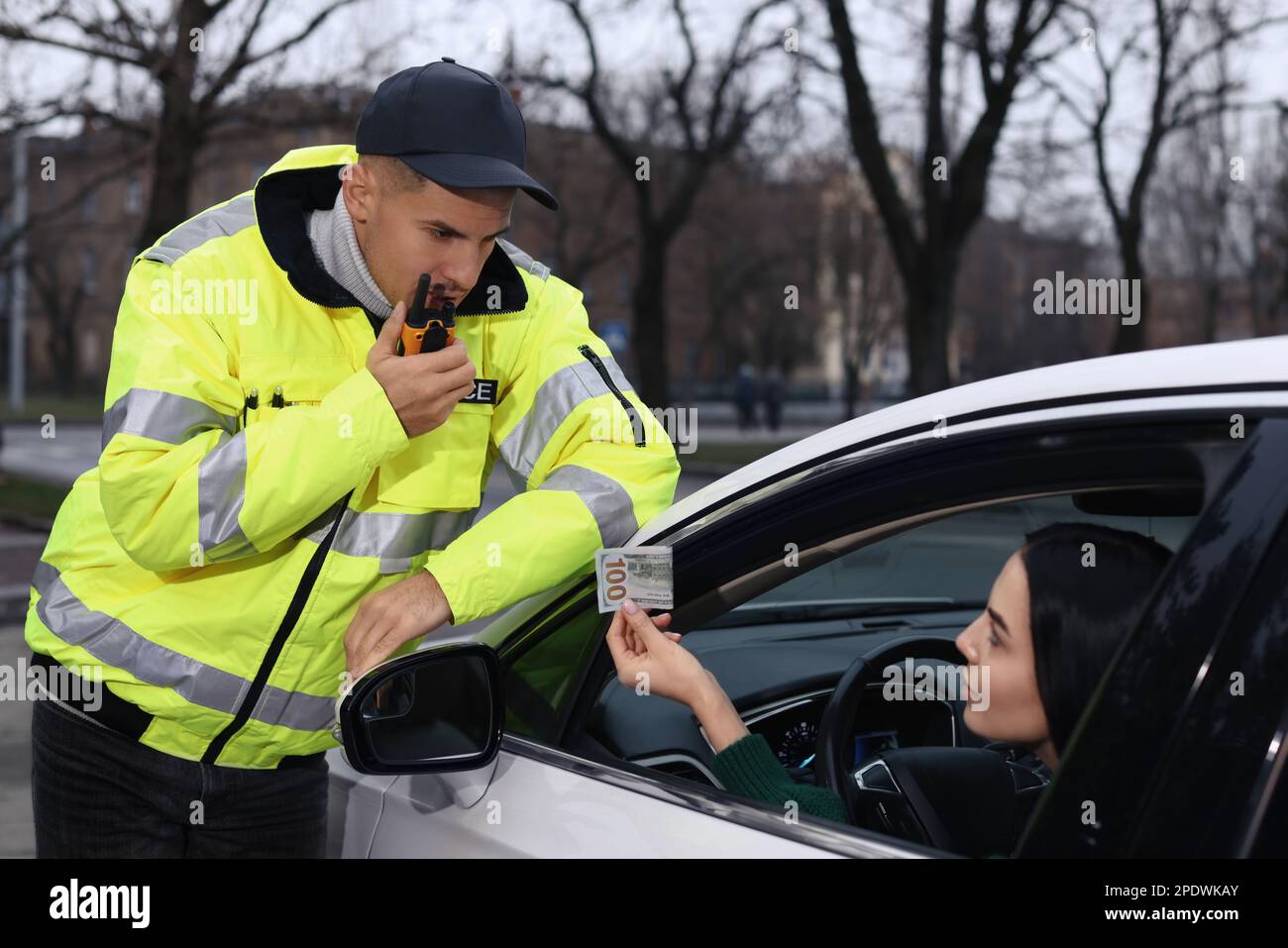 Woman giving bribe to police officer out of car window Stock Photo Alamy