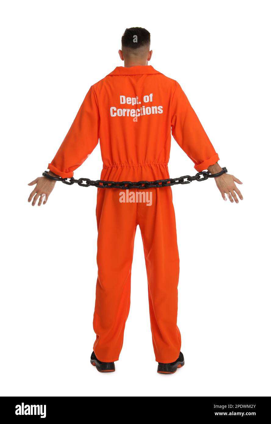Prisoner in orange jumpsuit with chained hands on white background, back view Stock Photo