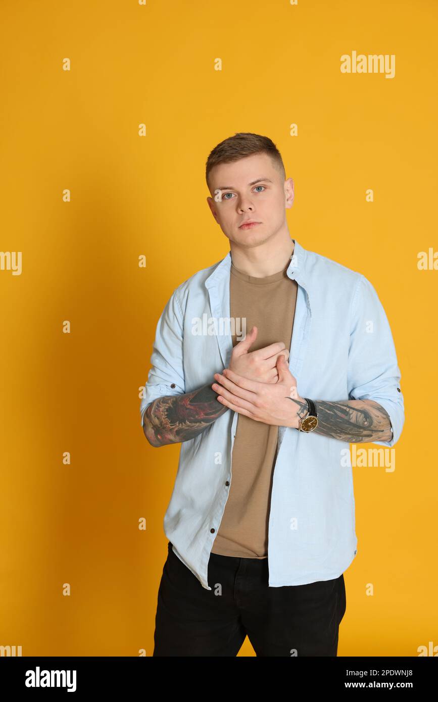 Young man with tattoos on arm hi-res stock photography and images - Alamy