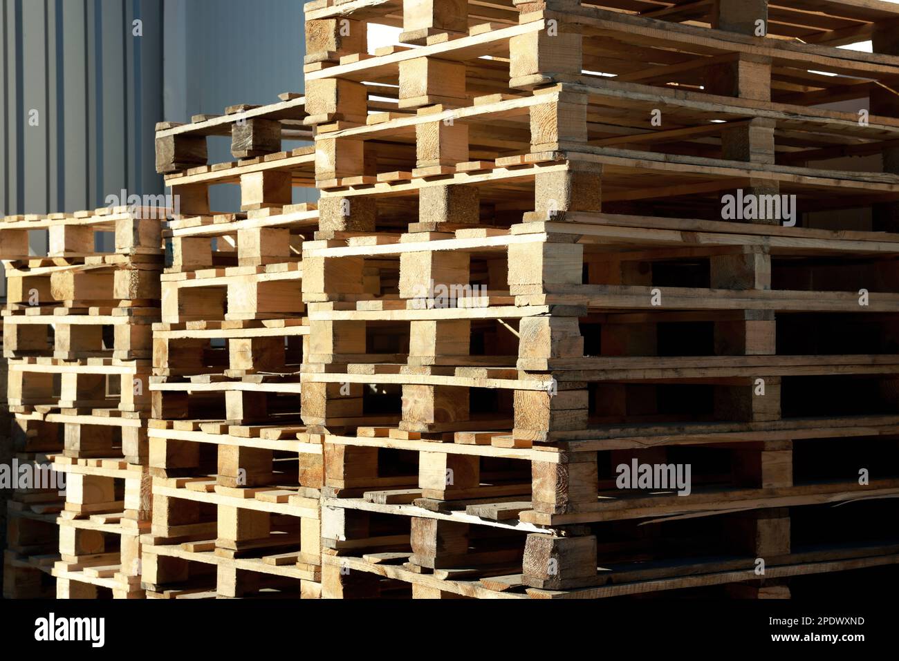 Many empty wooden pallets stacked in warehouse Stock Photo Alamy