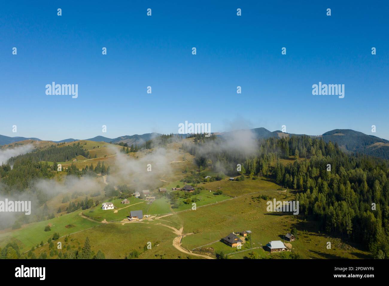 Aerial view of beautiful landscape with misty forest and village in ...
