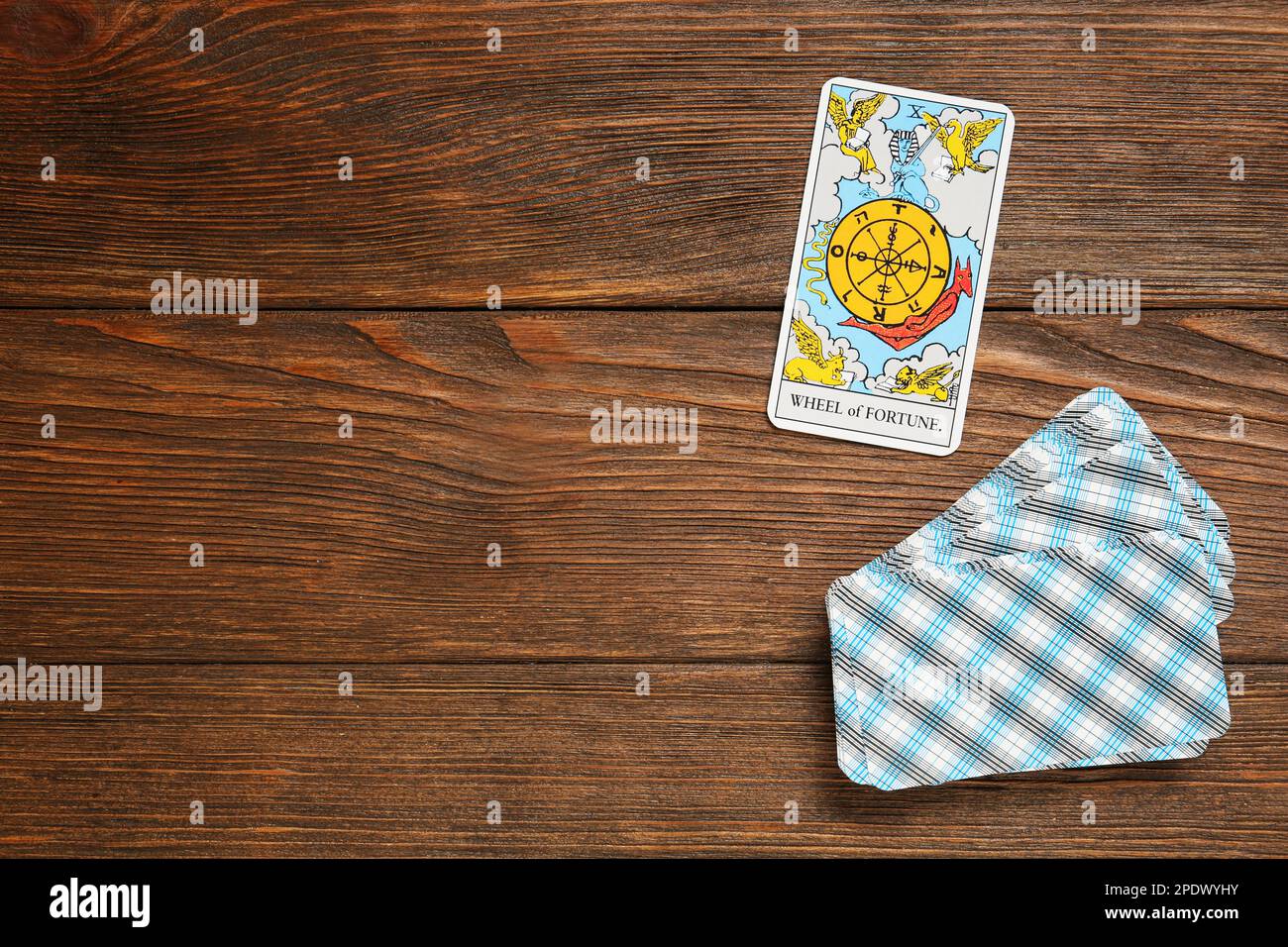 The Wheel of Fortune and other tarot cards on wooden table, flat lay. Space for text Stock Photo