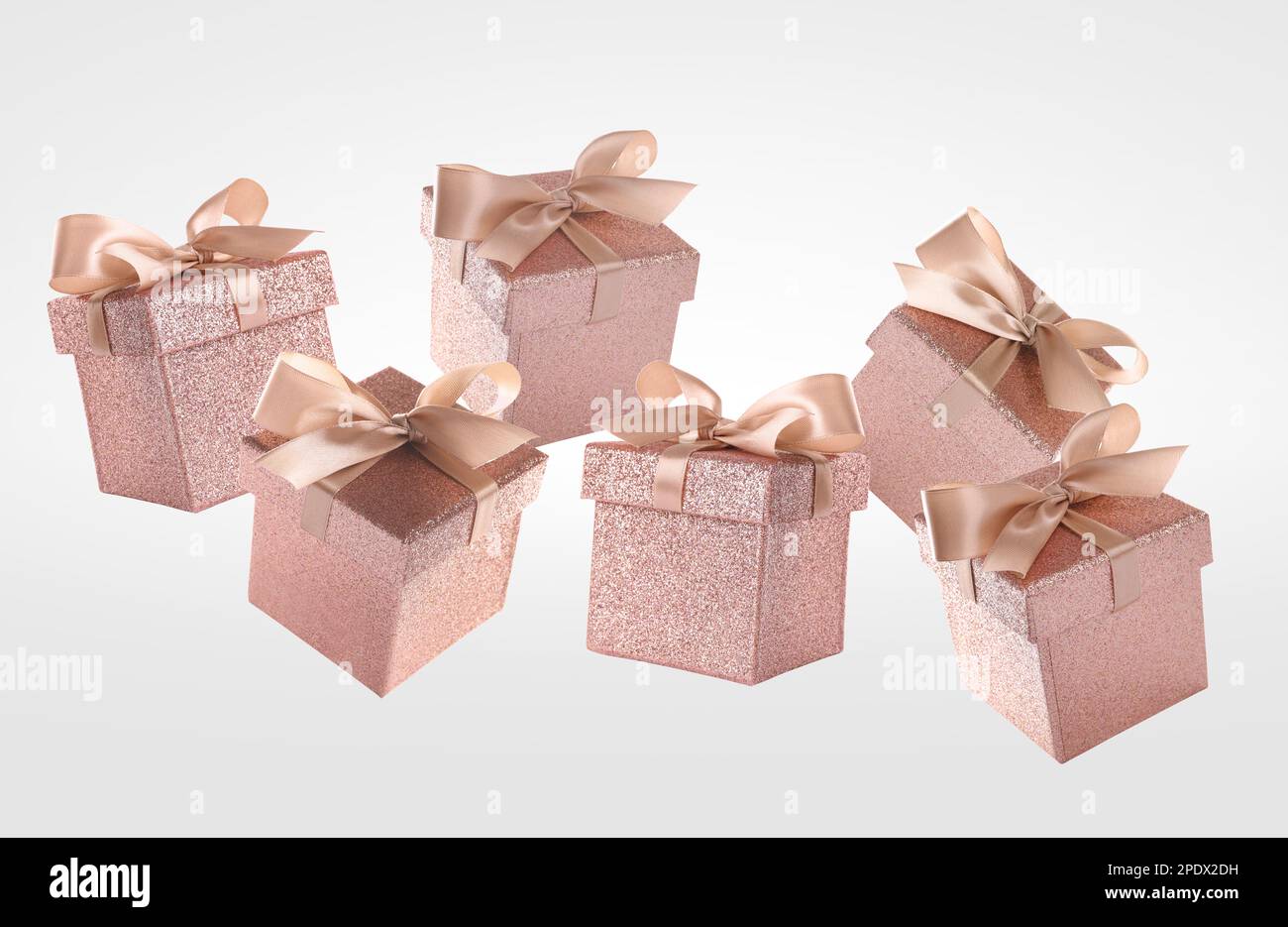 Beautifully wrapped gift boxes flying on white background Stock Photo