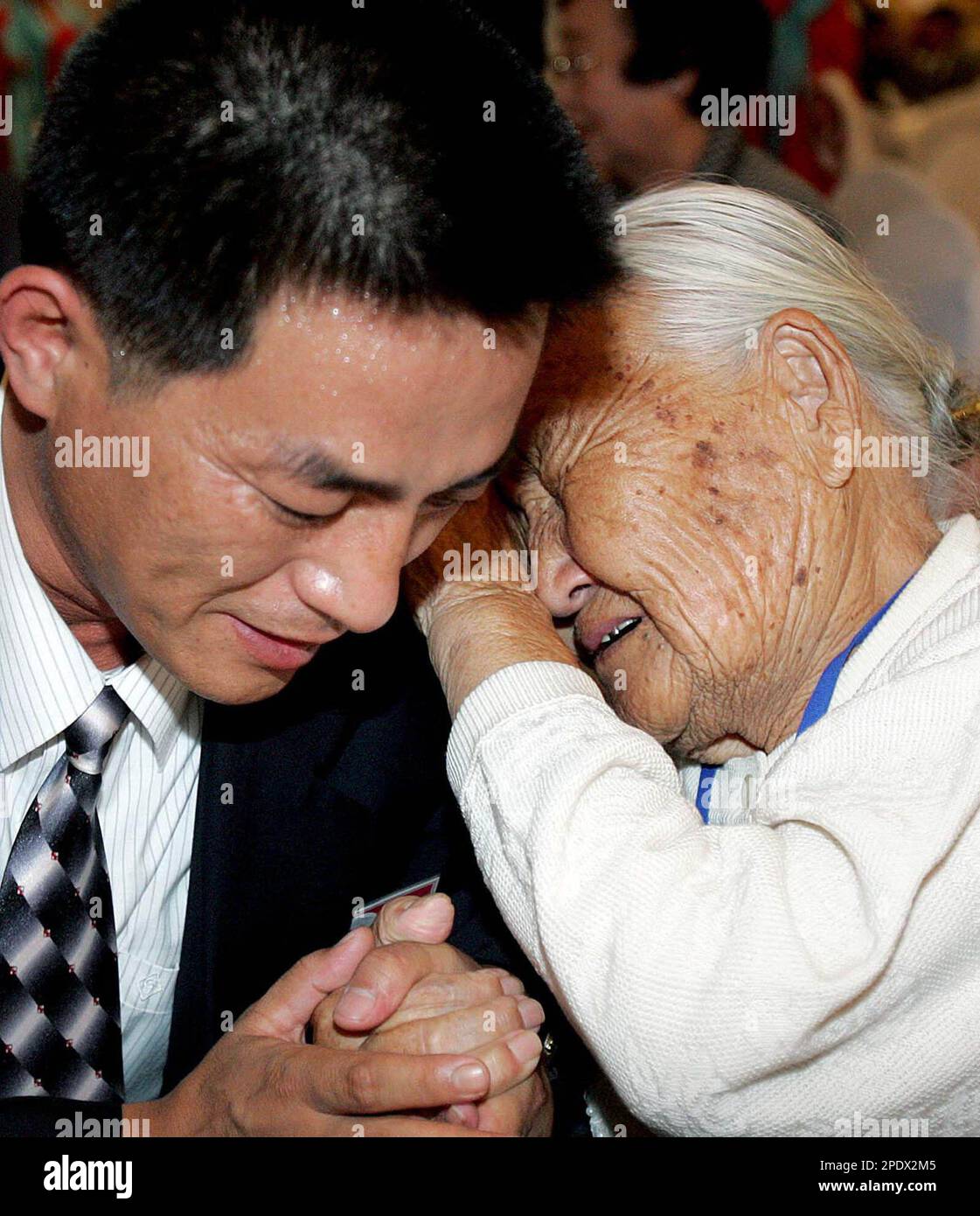 Kin Jon Ho South Korean Park Gan-nam, right, cries with her North Korean grandson ...