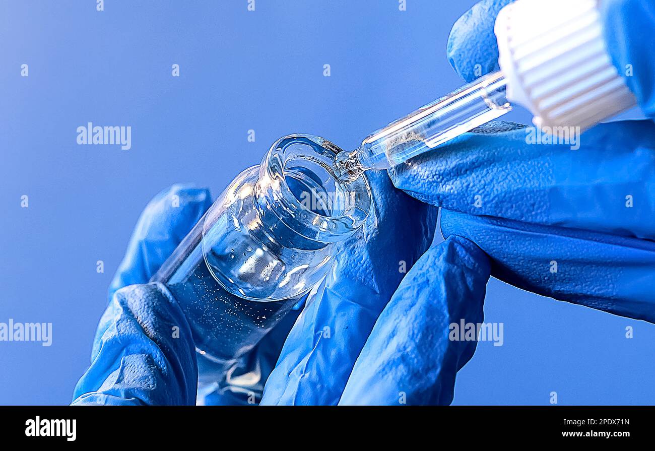 hands of a lab technician with a tube of blood sample , lab assistant ...
