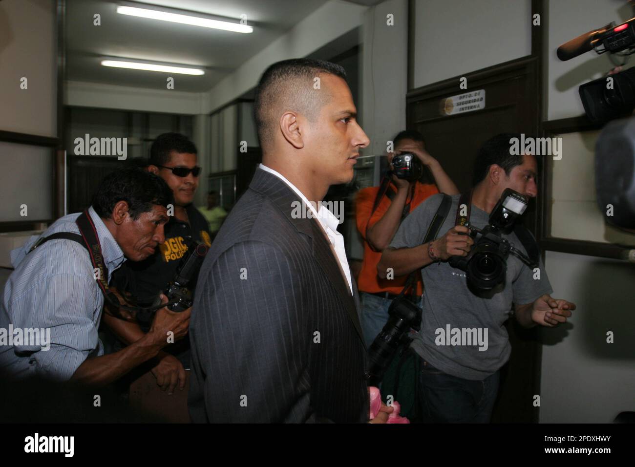 Honduras' former director of immigration Ramon Romero, center, walks ...