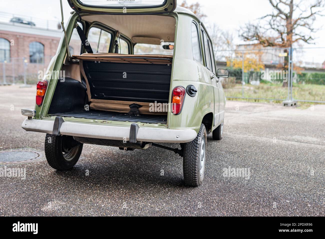 Side rear view of a vintage French car with the tailgate open and view