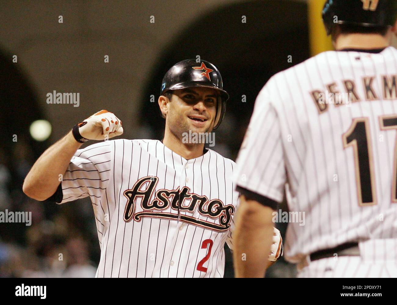 Houston Astros' Chris Burke (2) is congratulated by teammate Lance