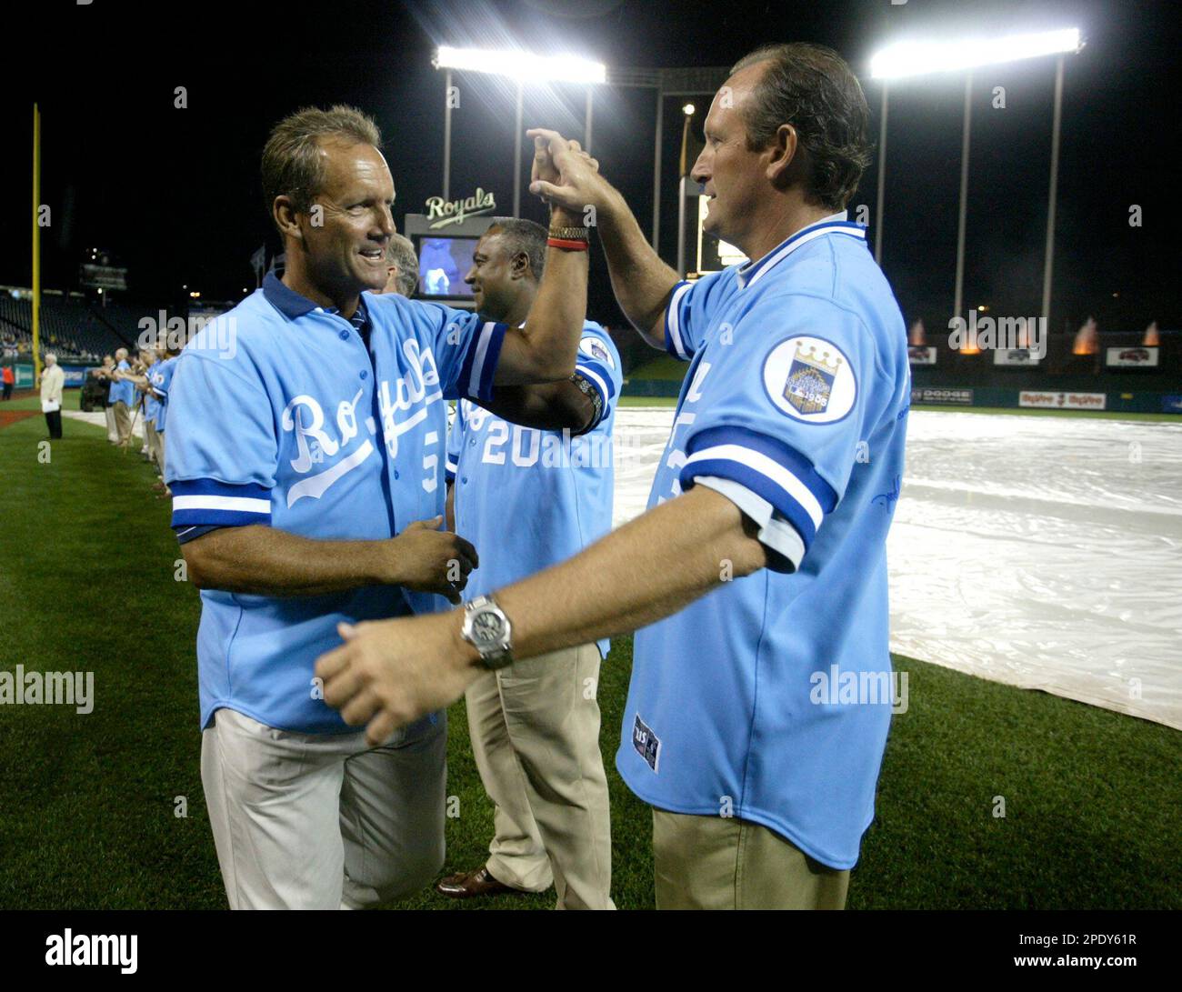 Former Kansas City Royals' George Brett, left, and Bret Saberhagen slap  hands as they are introduced as the Royals celebrate the 20th anniversary  of the 1985 World Series championship Friday, Aug. 12