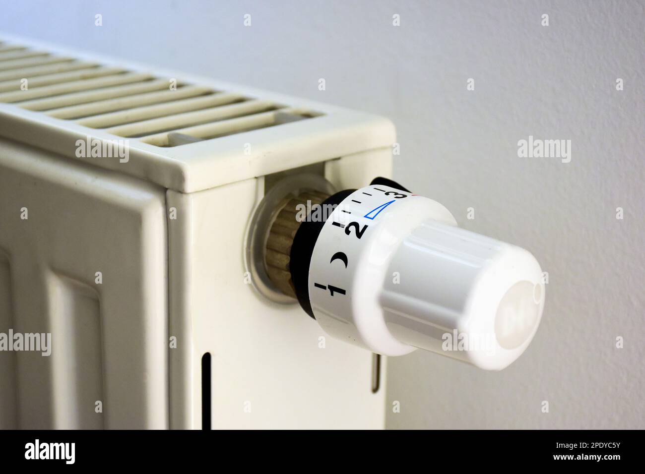 radiator temperature adjustment dial or knob in closeup view. heating regulator. natural gas usage concept. metal hot water heating unit detail. Stock Photo
