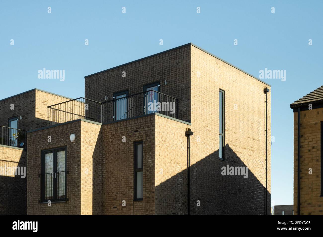Brick building, residential apartments or flats, Salford, Manchester, England, UK. Clear blue sky, generic, copy space, minimalist, modern Stock Photo
