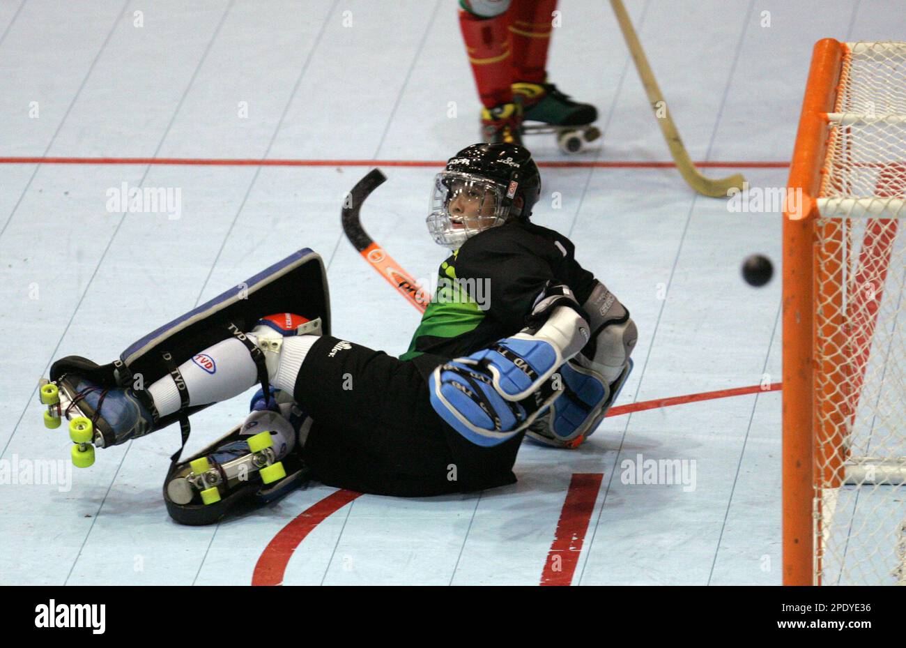Portugal defense Valter Neves, not shown, scores against Macau goalie  Arnaldo Silva in the first half of the third round of the Men's Hardball Roller  Hockey Championship in San Jose, Calif., Tuesday,