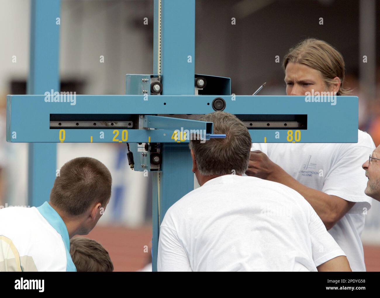 Stadium officials check the heightmeasuring device after it failed