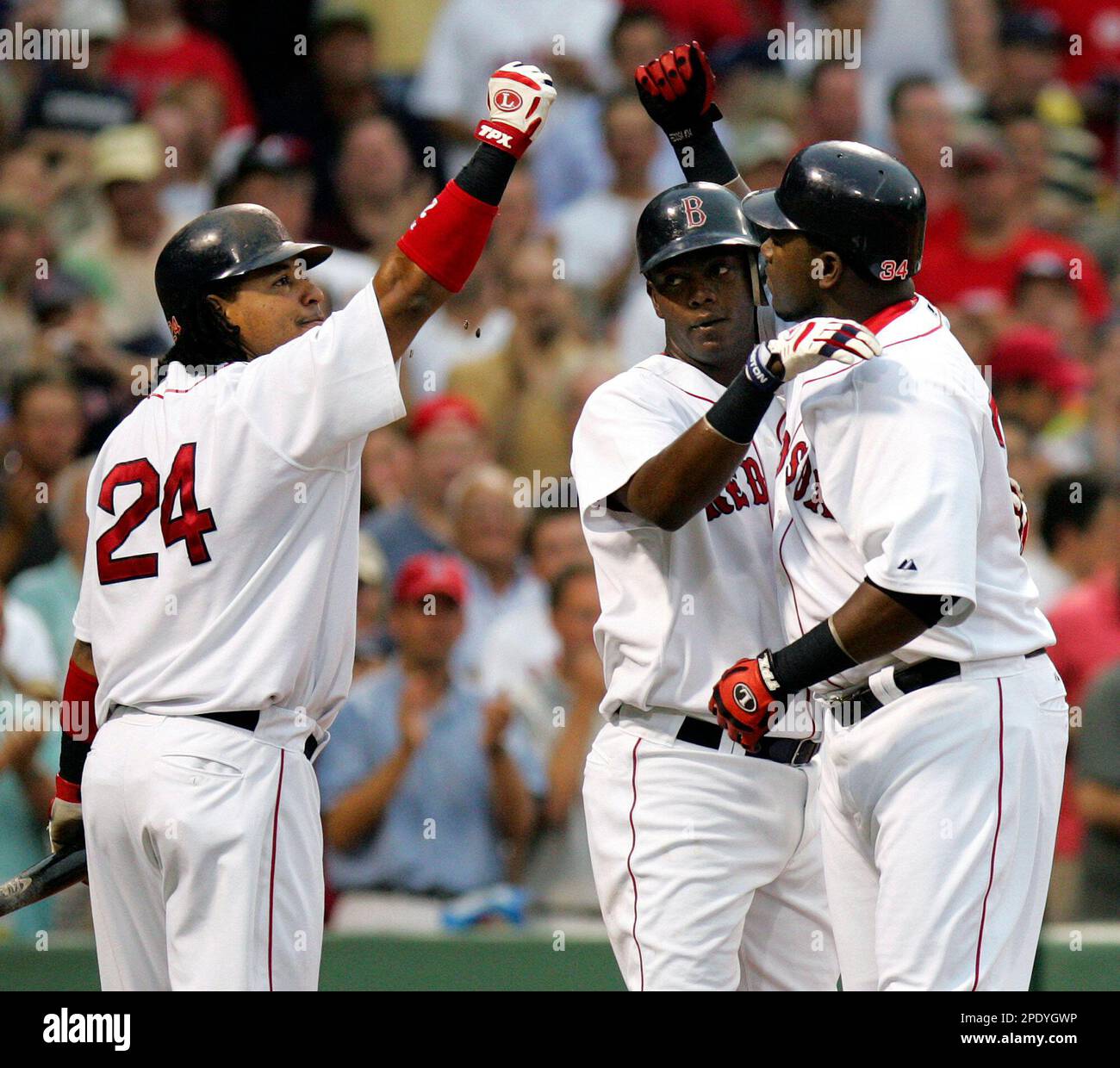 Boston Red Sox's David Ortiz, right, receives congratulations from Manny  Ramirez (24) with Edgar Renteria in the middle after Ortiz hit a three-run  homer in the eighth inning against the Chicago White