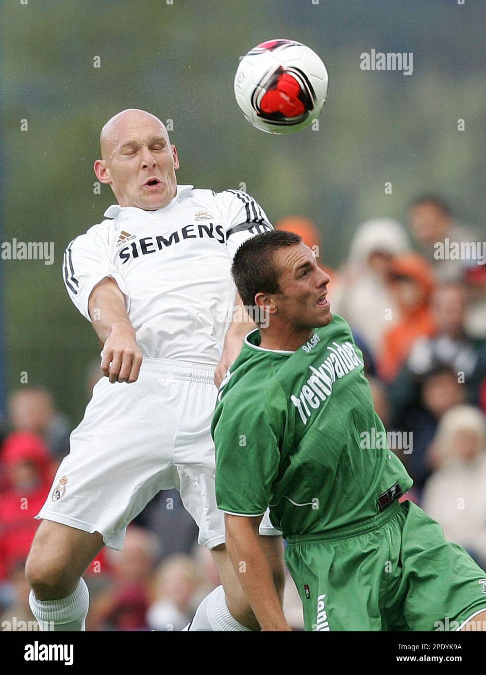 Real Madrid's Thomas Garvesen, left, challenges for the ball with ASK Trenkwalder's Reinhard Burits during a friendly soccer match Sunday, Aug.7, 2005, in Irdning, Austria. Real Madrid is on pre-season training camp in Austria. (AP Photo/Andreas Schaad) Stock Photo