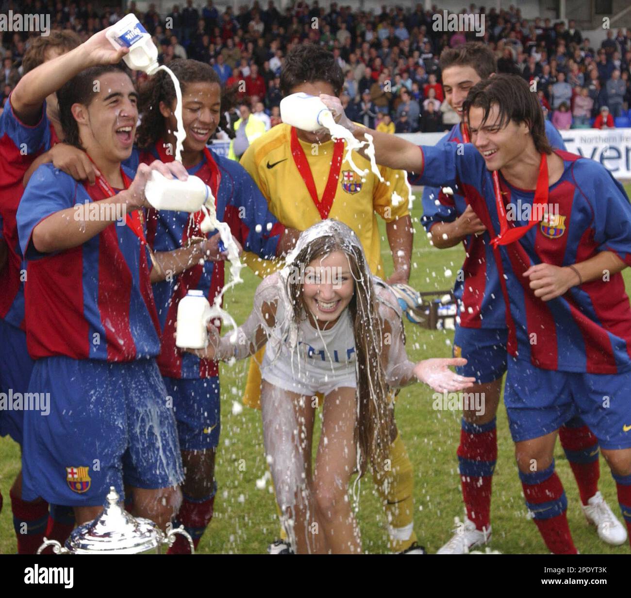 Barcelona soccer players shower hostess Katie Larmour with milk as they