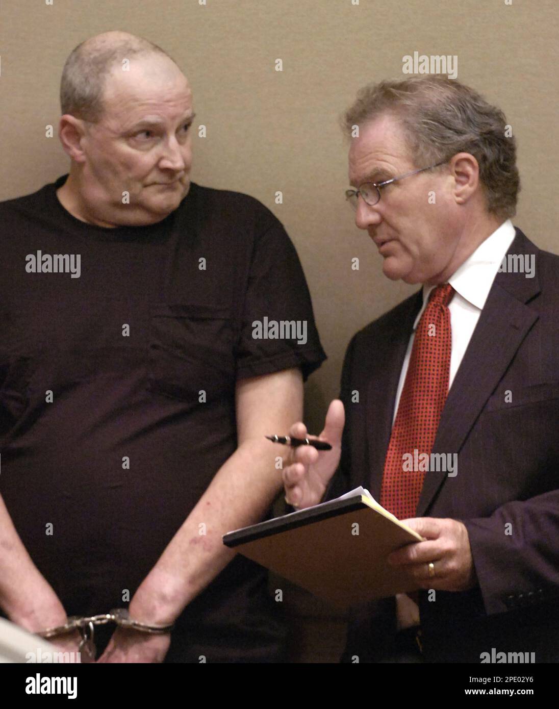 Walter Bishop, 60, left, stands in the arraignment session of Brockton  (Mass.) District Court, Tuesday, Aug. 2, 2005, and listens to defense  attorney Kevin Reddington, of Easton. Bishop on Tuesday was ordered