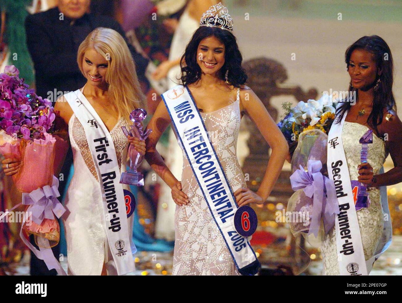 The 34th Miss Intercontinental Emmarys Pinto, center, from Venezuela, the first runner-up Sarianna Kankaristo, left, from Finland, and the second runner-up Shauntavia Loo, right, from Norway greet the audience in Huangshan, east China's Anhui province, on Saturday July 30, 2005. Sixty-one contestants from 60 countries around the world attended the 34th Miss Intercontinental Final. (AP Photo/Xinhua, Wang Lei) Stock Photo