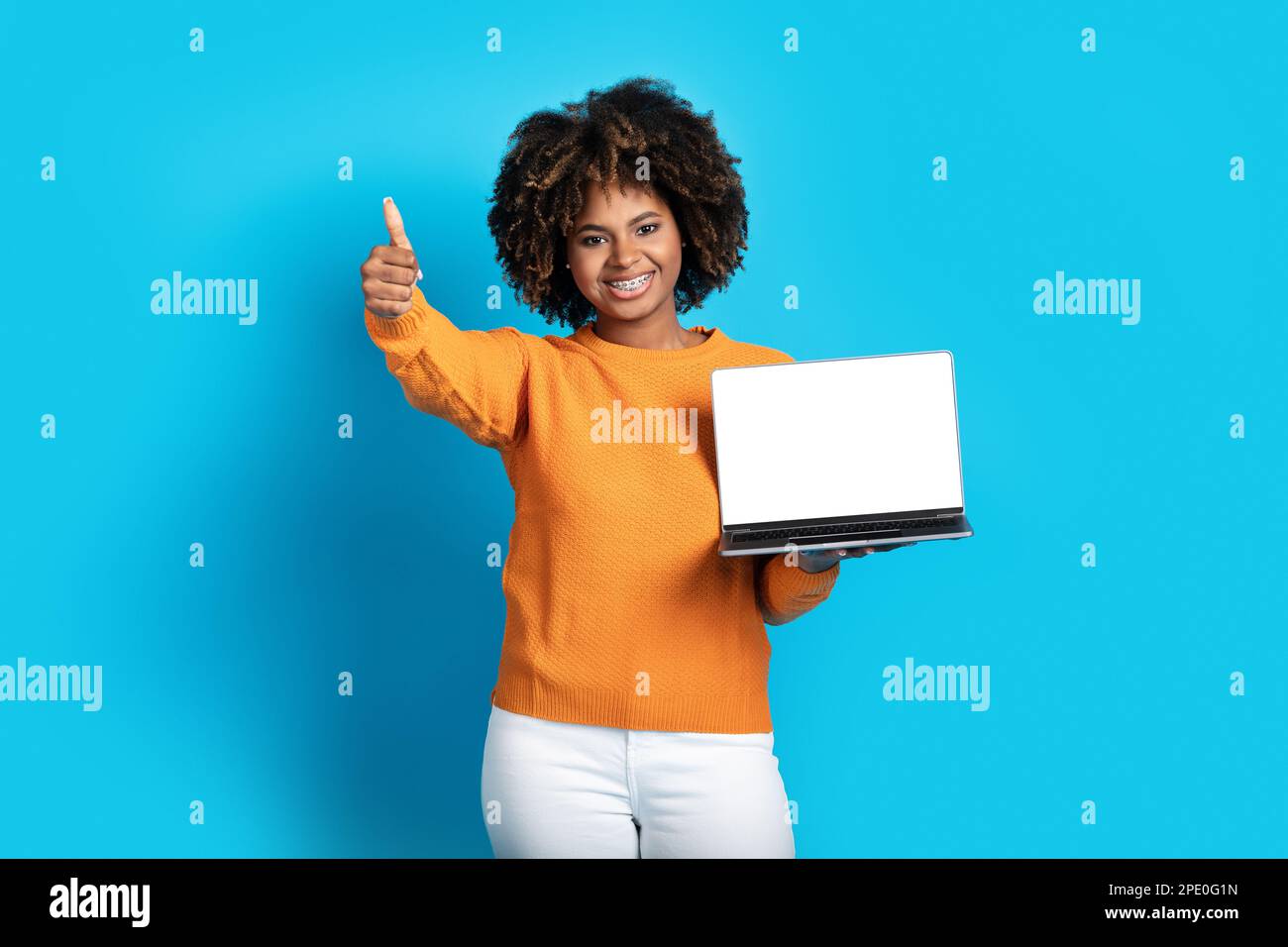 Attractive african american woman showing laptop blank screen Stock ...