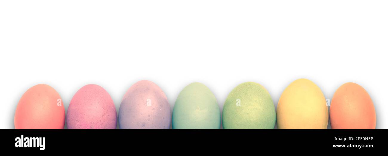 Line of rainbow colored pastel Easter eggs isolated on white background, Easter web banner with copy space Stock Photo