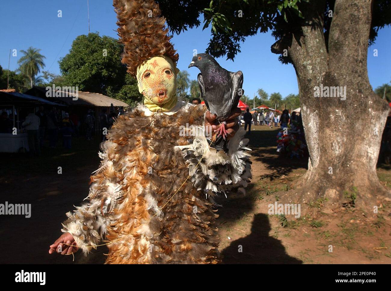 Francisco Mereles, 21, dressed in feathers as a religious promise to San  Fracisco Solano, attends a ceremony in Emboscada, some 30 milles south of  Asuncion, Paraguay, on Sunday, July 24, 2005. San