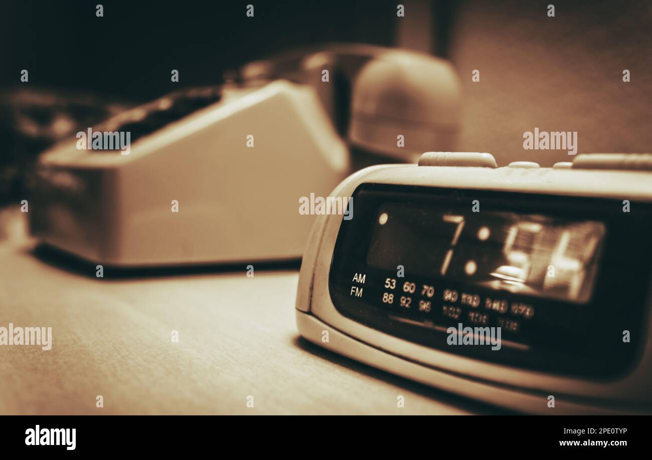 Vintage Hotel Room alarm Clock and the Analog Phone Close Up. Sepia