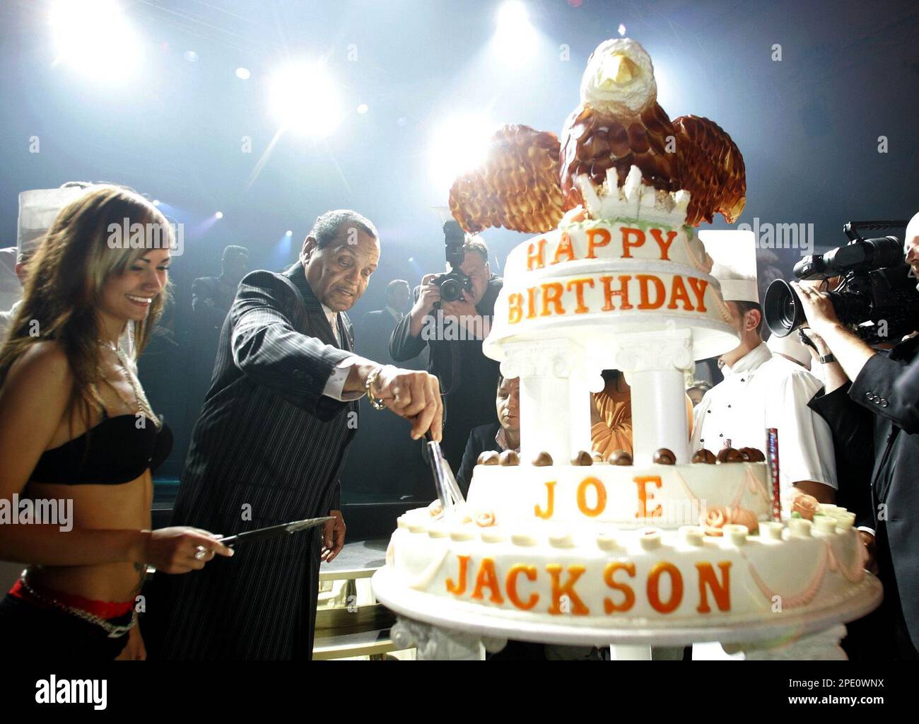 Joseph Jackson, center, father of popstar Michael Jackson, cuts his birthday  cake in Berlin Friday, July 22, 2005. Friday Jackson celebrated his 76th  birthday with a big party in town. Left is