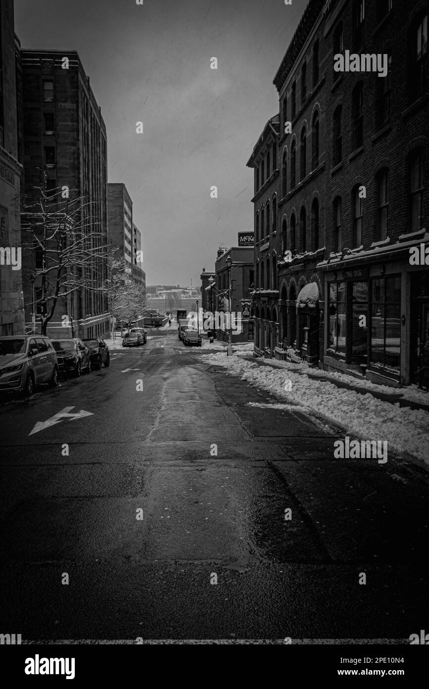 looking down Prince Street in the The Brick District on a cold winter day with snow covered sidewalks Stock Photo