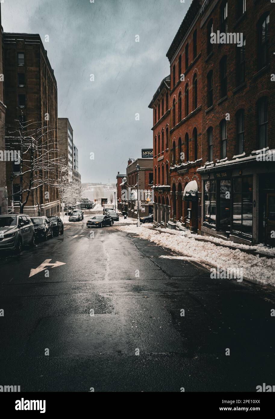 looking down Prince Street in the The Brick District on a cold winter day with snow covered sidewalks Stock Photo