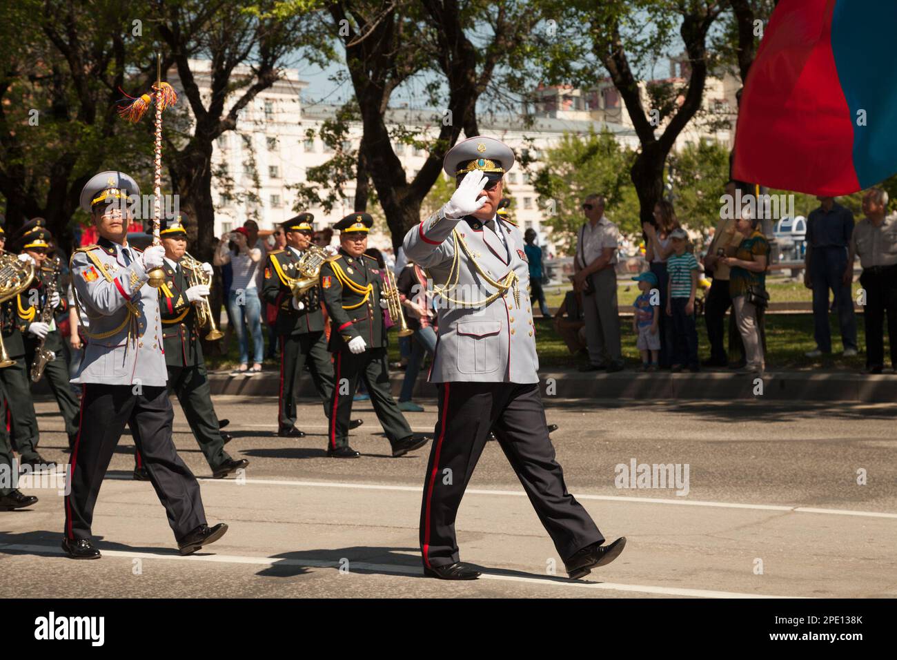 Khabarovsk, Russia - May 28, 2017: Brass orchestra marching performance. Asian musicians in uniform playing wind instruments on parade.  IV internatio Stock Photo