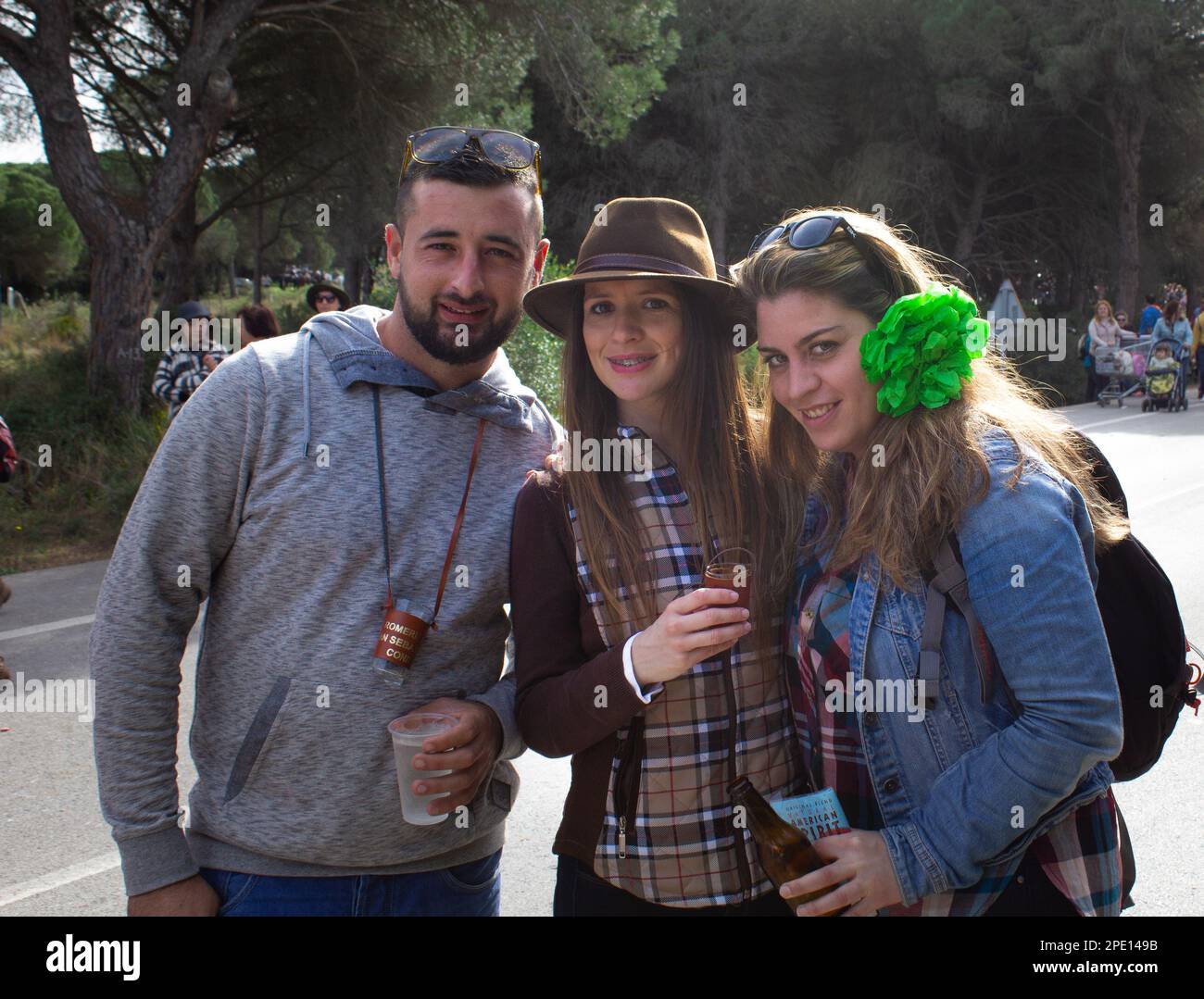 3 friends at a parade in Spain Stock Photo