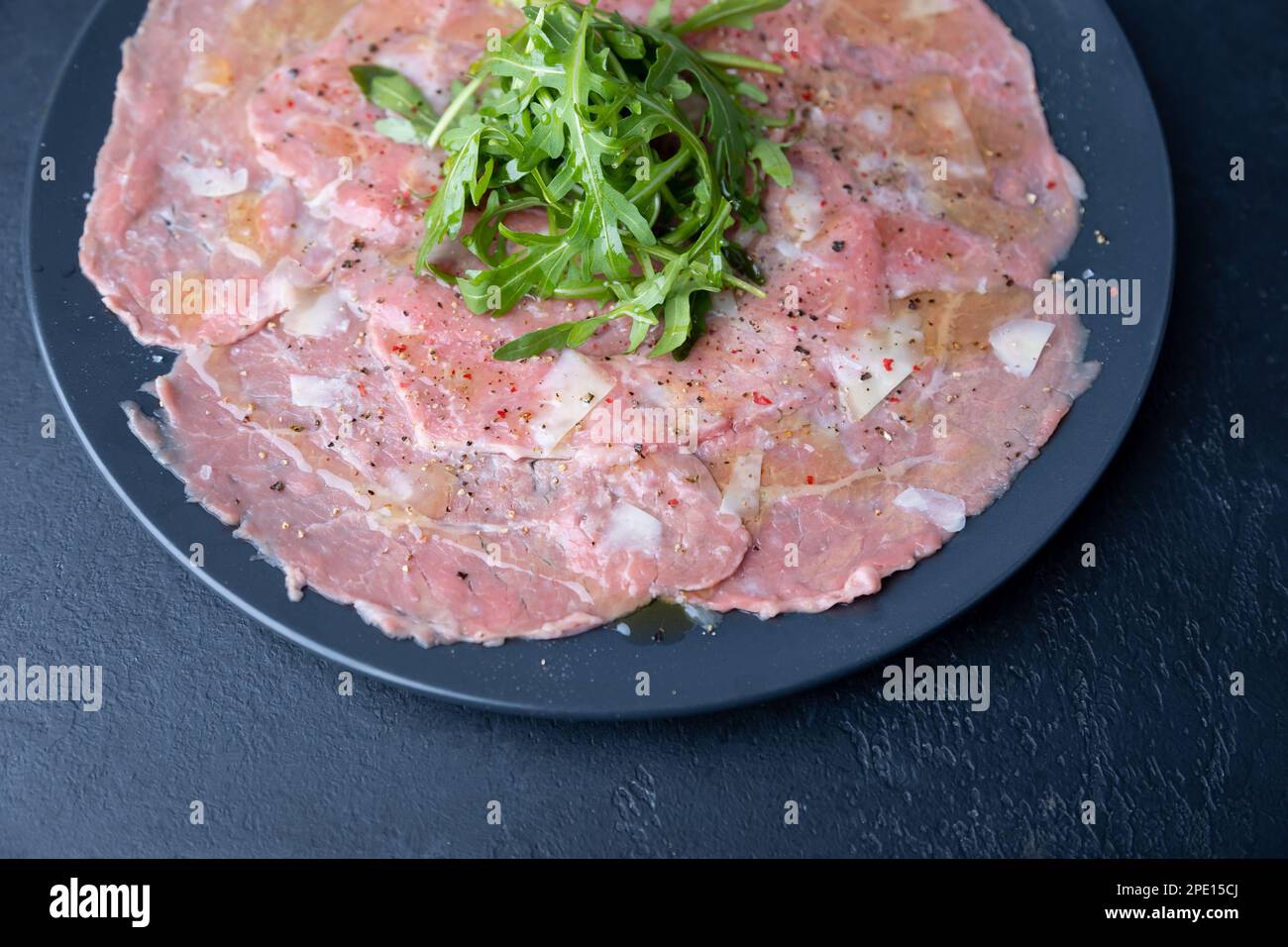 Marbled beef carpaccio with arugula, parmesan cheese, olive oil and