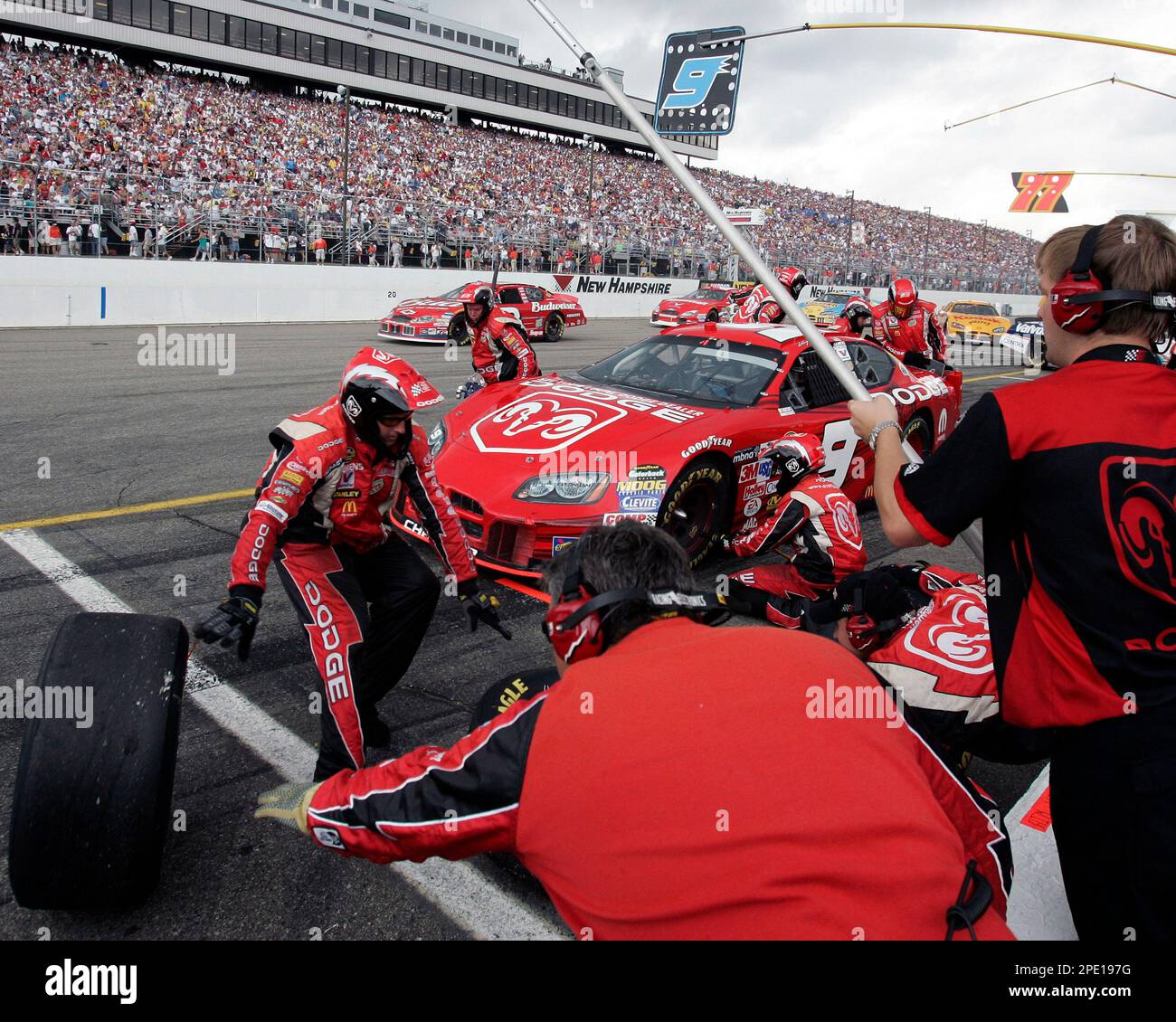The pit crew for the Dodge Dealers/UAW Doge race car works on the left