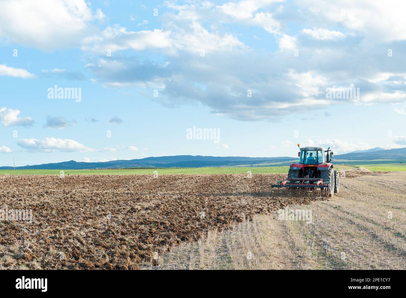 agricultural machinery working the land in the field Stock Photo