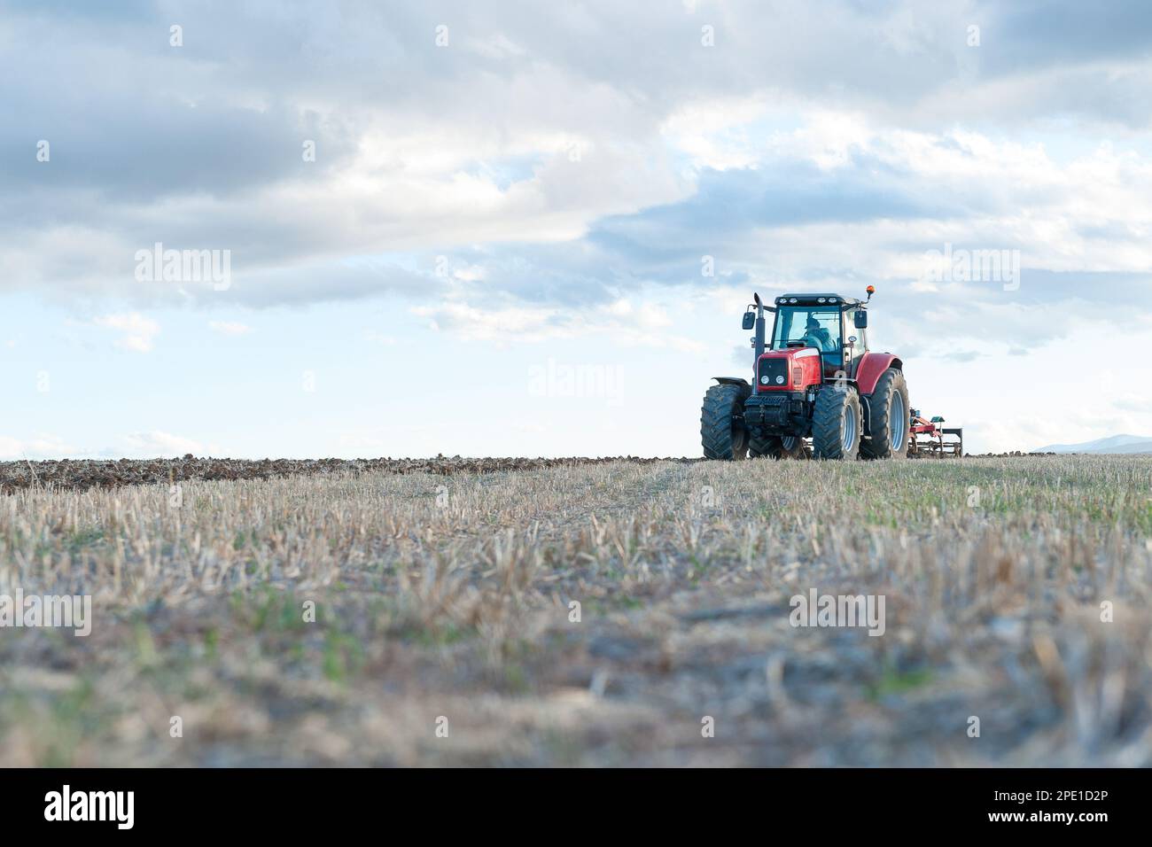 agricultural machinery working the land in the field Stock Photo
