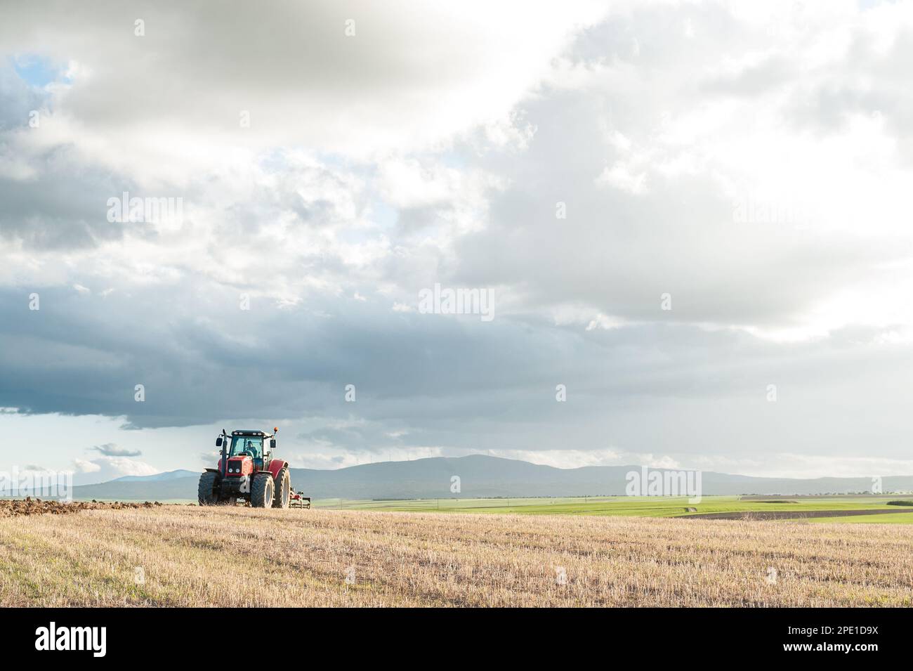 agricultural machinery working the land in the field Stock Photo