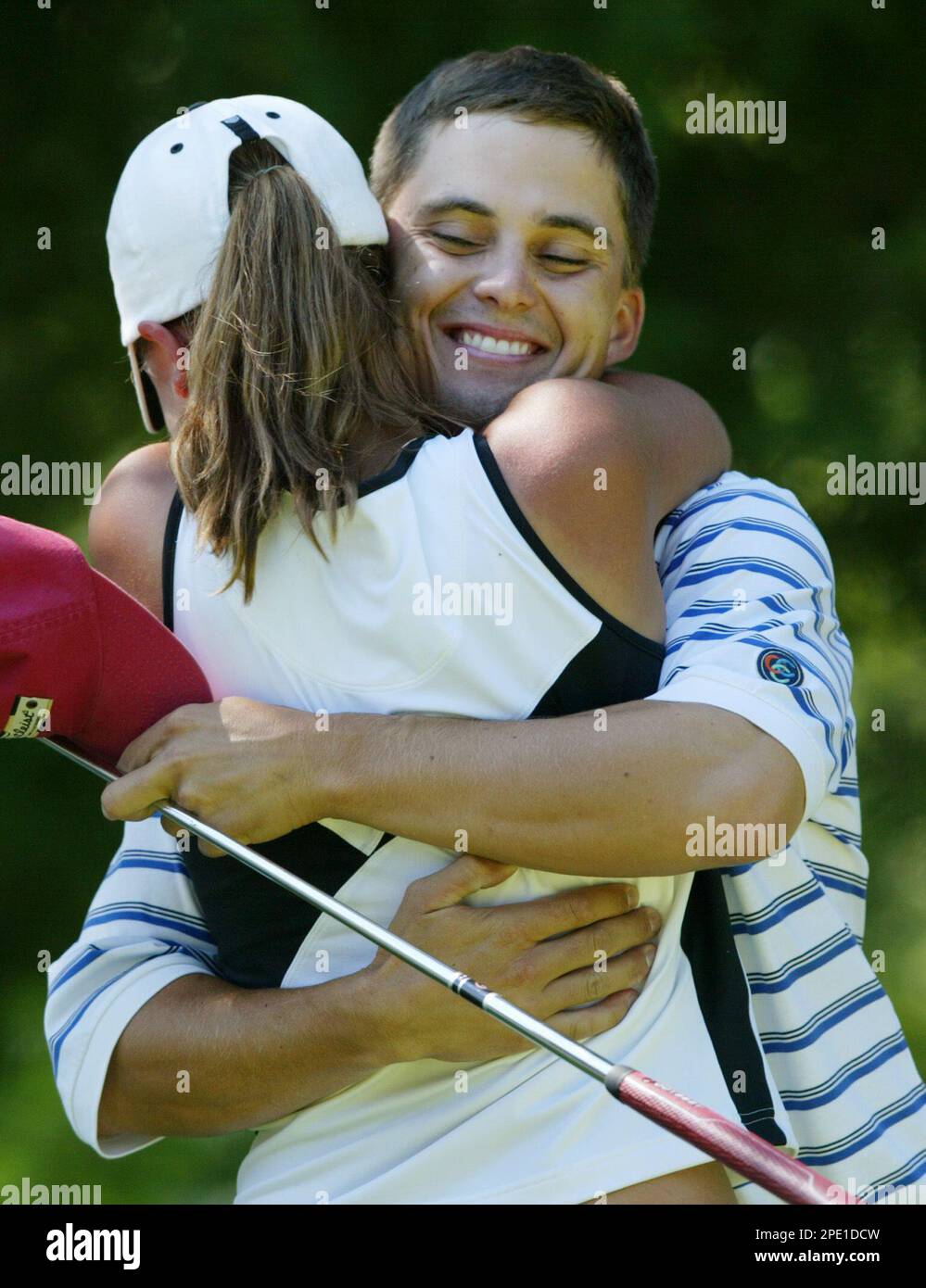 Corey Poulin, right, gets a hug from his sister and caddy, Crystal