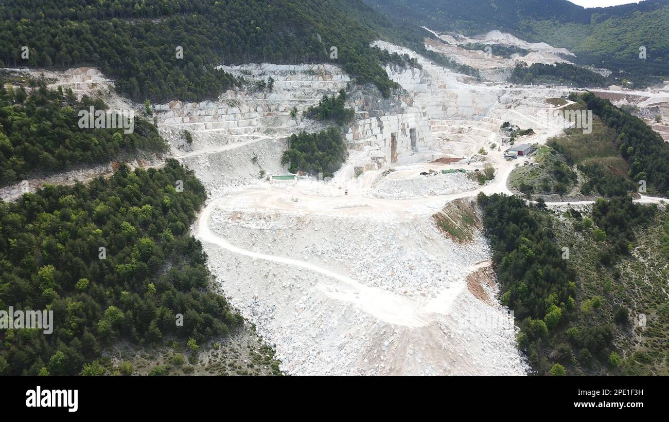 Heavy machines working at a huge marble quarry in Europe. Transporting