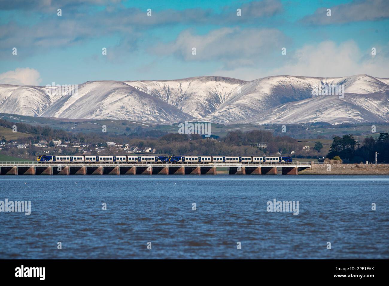A view of snow on the Yorkshire Dales fells from Arnside, Milnthorpe, Cumbria, UK Stock Photo