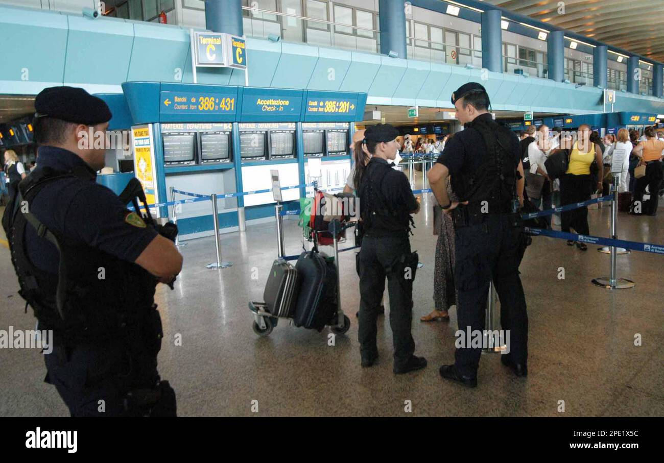 Italian police officers patrol Terminal C at Rome's Fiumicino Airport ...
