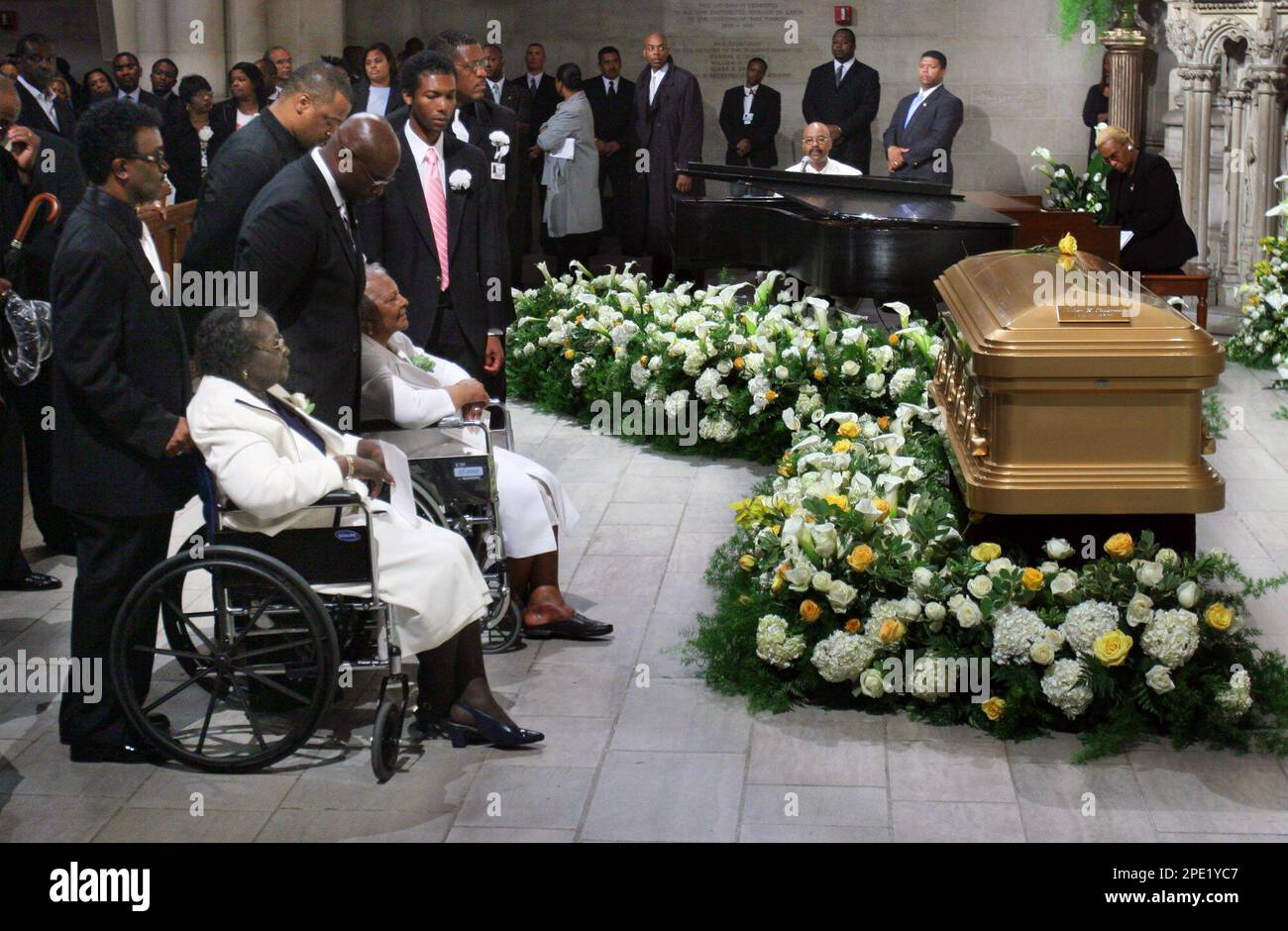 Mary Ida Vandross, at left in wheelchair, views the casket of her son