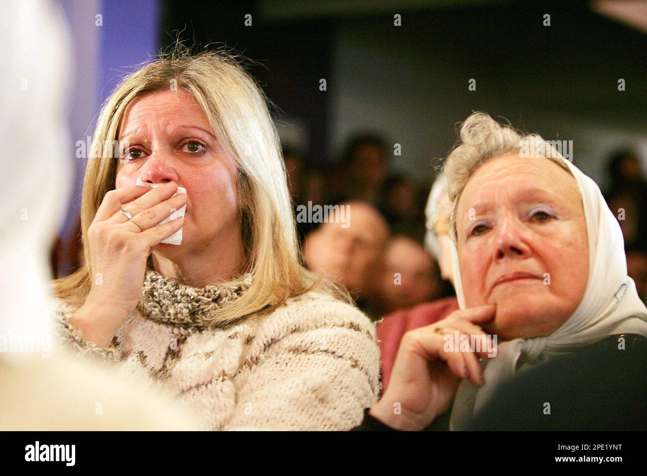 An unidentified woman cries beside Nora Cortinas, right, of the human rights group Mothers of Plaza de Mayo as they attend a news conference offered by an anthropologist in Buenos Aires, Friday, July 8, 2005, where it was announced that the remains of Esther Ballestrino de Careaga, Maria Ponce de Bianco and Azucena Villaflor, the three missing women who founded Mothers of Plaza de Mayo human rights group, were found and identified in a cemetery in the south of Buenos Aires. The three women were abducted in December 1977 while trying to find the fate of their missing children. (AP Photo/Natacha Stock Photo