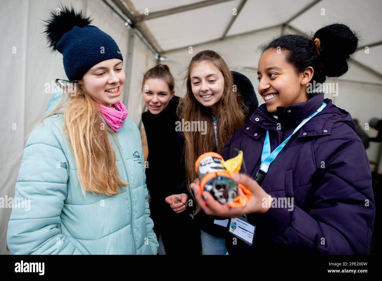 15 March 2023, Lower Saxony, Rotenburg (Wümme): Participants Elisa (l-r), Sophia, Charlotte and Rahel from the 'ClouDDSat' team from Dresden hold a mini-satellite with associated parachute in their hands. Eight German student teams flew self-designed mini satellites from the Rotenburg (Wümme) airfield in the CanSat competition organized by the German Aerospace Center (DLR). The so-called CanSats ('can satellites') were launched one kilometer into the air with rockets, then floated back to earth on parachutes. Photo: Hauke-Christian Dittrich/dpa Stock Photo