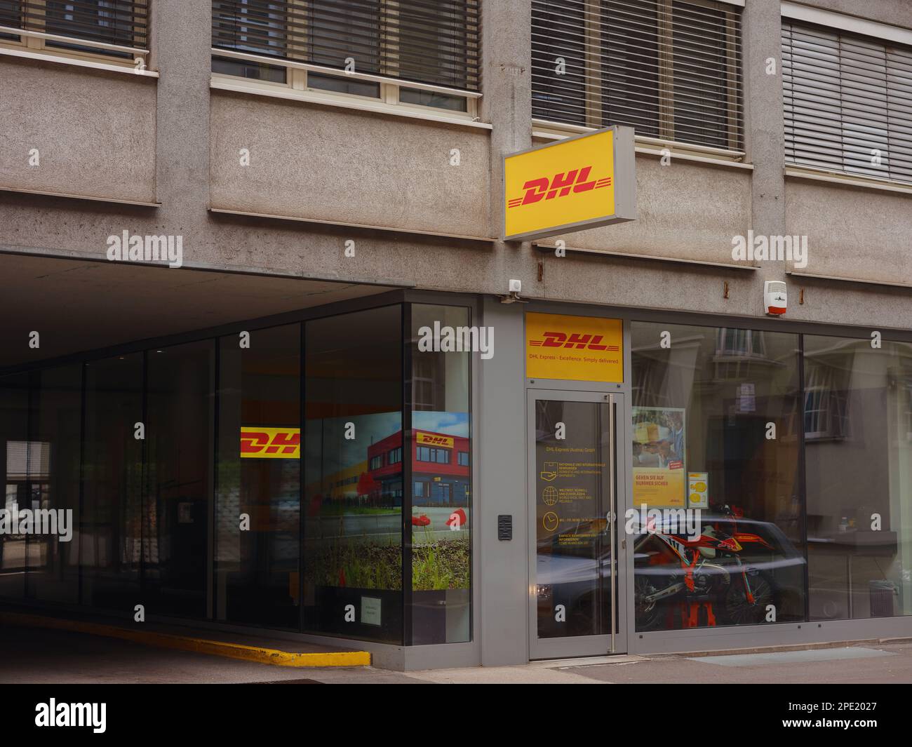 Salzburg, Austria - August 6, 2022: DHL delivery point. Dhl is global market leader in logistics industry. It commits its expertise in international parcel, express, air and ocean freight, road and rail Stock Photo