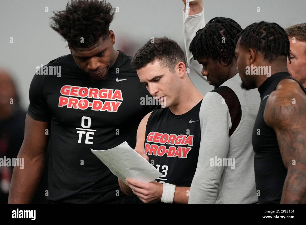 Former quarterback Stetson center, talks with teammates along with former