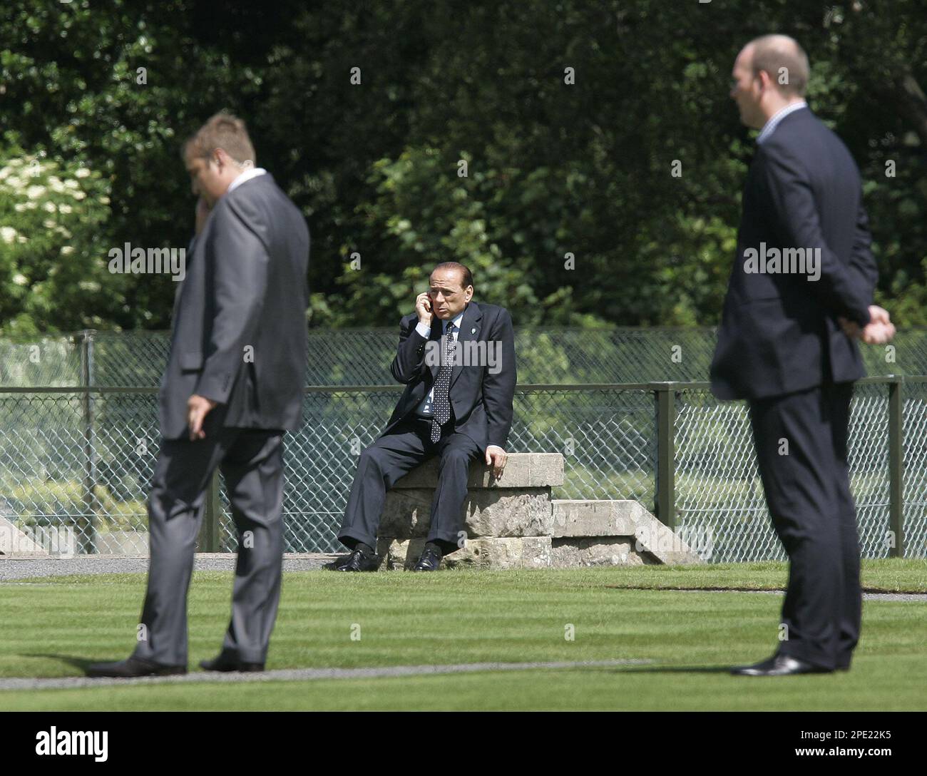 Italian Prime Minister Silvio Berlusconi makes a call during a break in