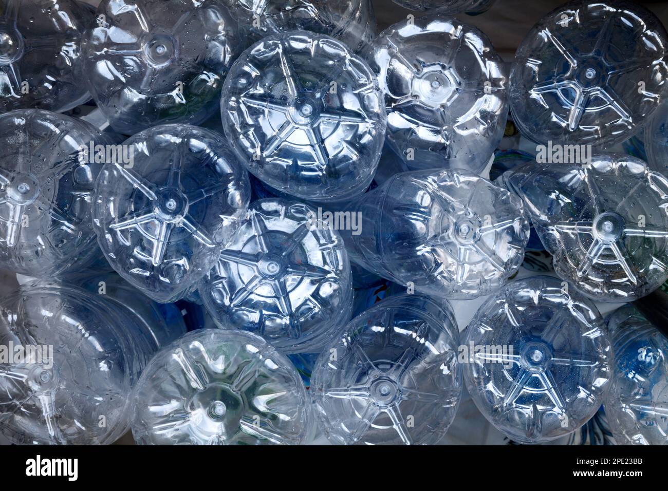Many used plastic bottles pile background. Clear empty water containers piled at a garbage recycling plant Stock Photo