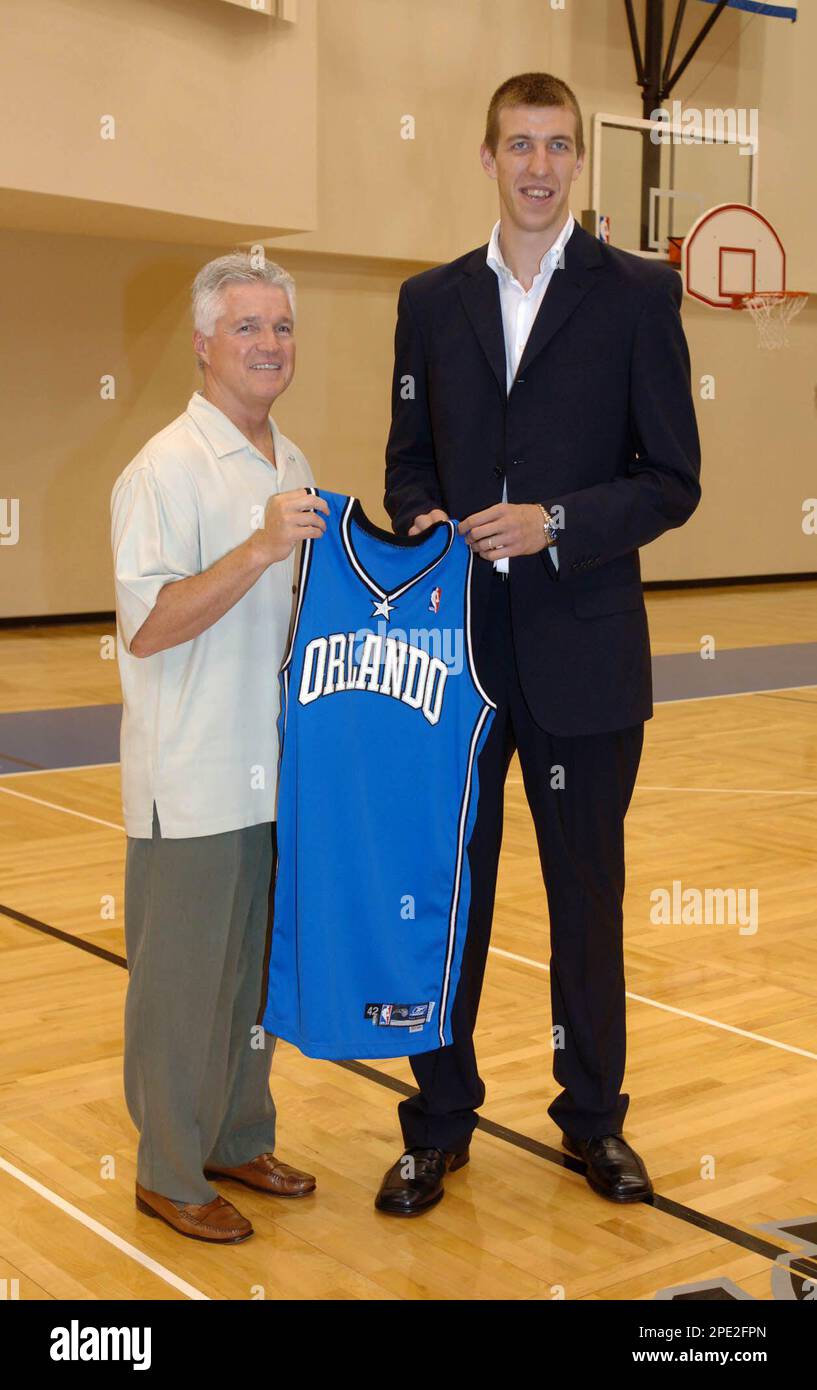 Orlando Magic first-round draft pick Fran Vazquez, of Spain, right, holds a  jersey with coach Brian Hill during a news conference introducing him to  the local media at the RDV Sportsplex in