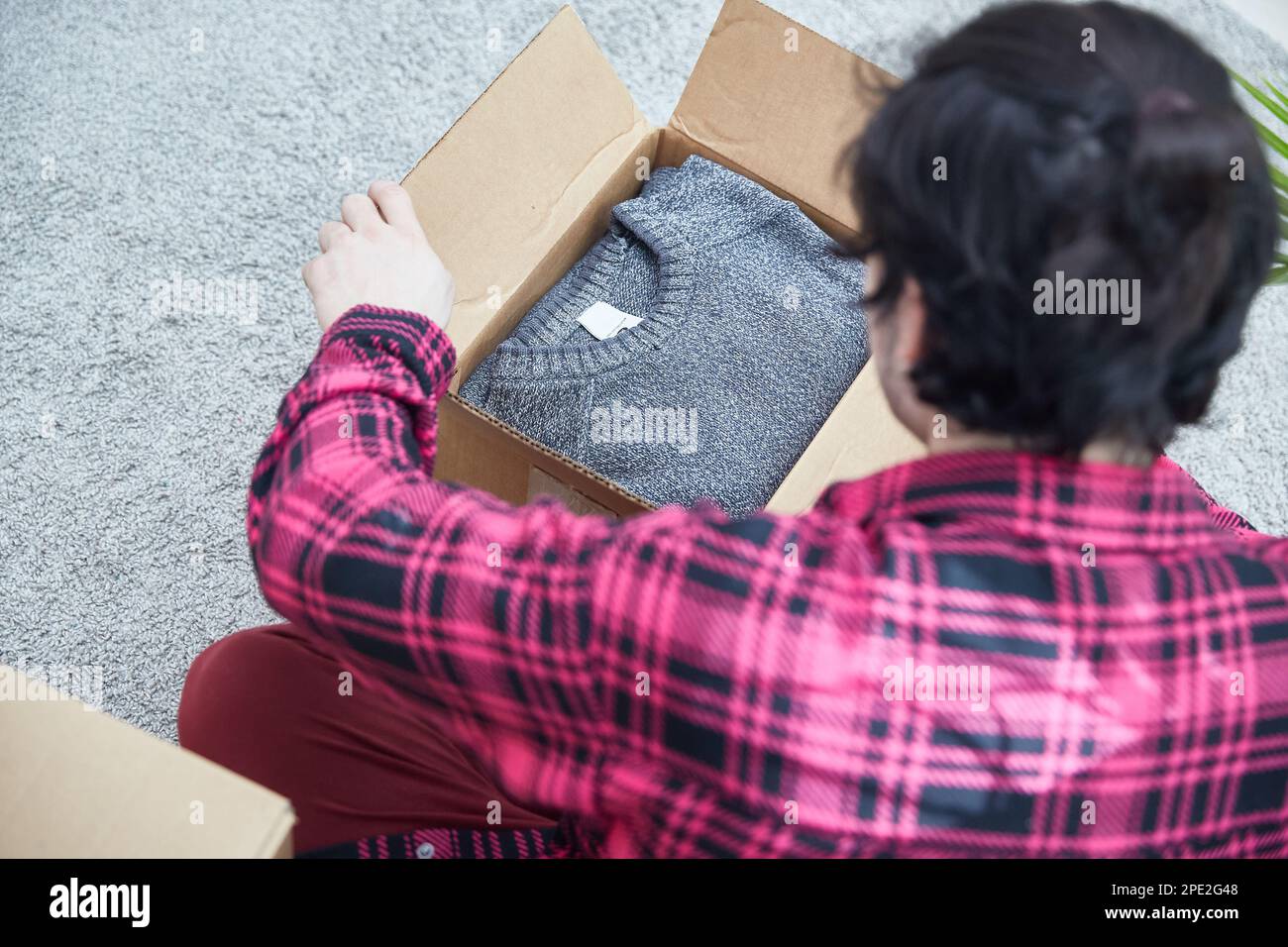 The guy is opening a box of things. Top view Stock Photo - Alamy
