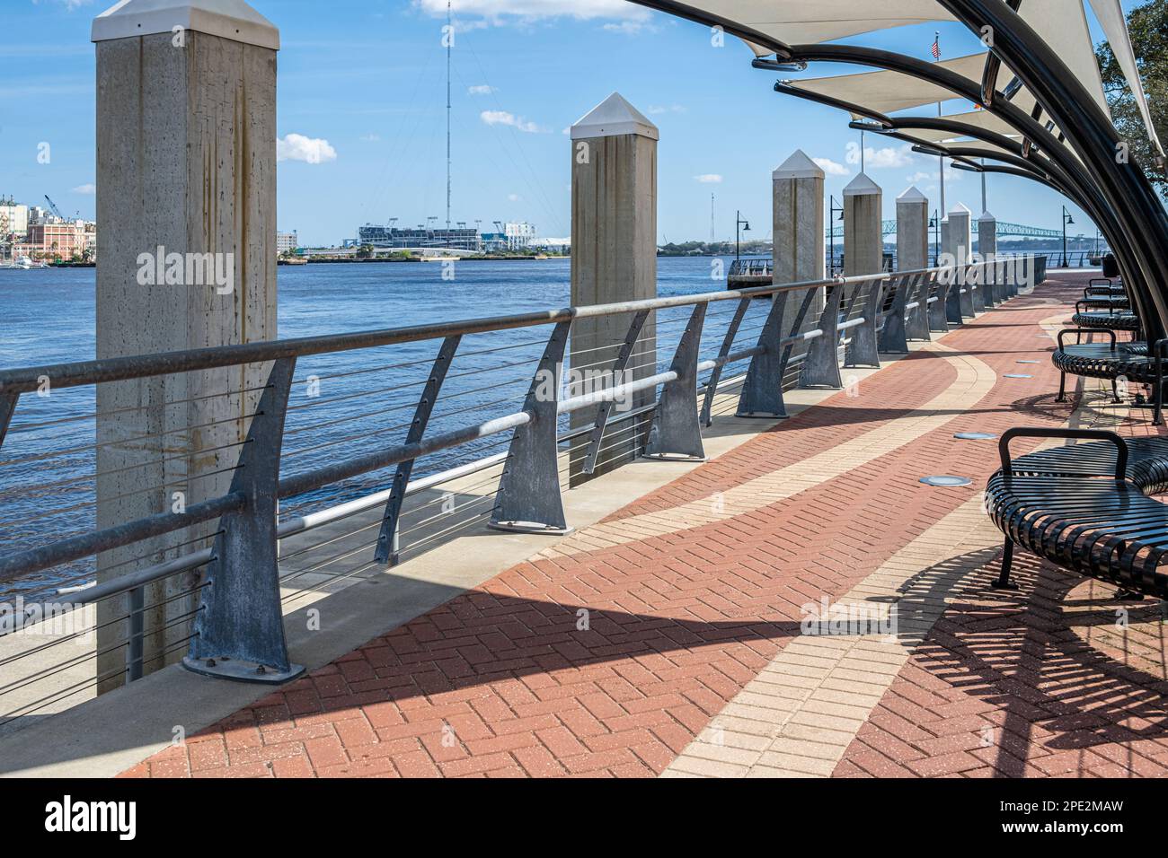 Jacksonville, Florida's downtown Southbank Riverwalk along the St. Johns River with the Jacksonville Jaguars Stadium in the background. (USA) Stock Photo